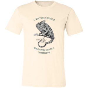 A cream-colored T-shirt features a detailed black-and-white illustration of a chameleon on a branch. Above the chameleon, text reads “ALWAYS BE YOURSELF,” and below, “UNLESS YOU CAN BE A CHAMELEON.” The design is centered on the chest.