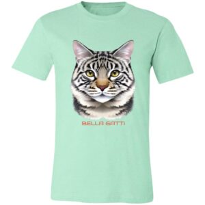 A mint green t-shirt features a realistic illustration of a gray tabby cats face, with green eyes and pink ears. Below the cat’s face, the words “BELLA GATTI” are printed in bold, light red capital letters.