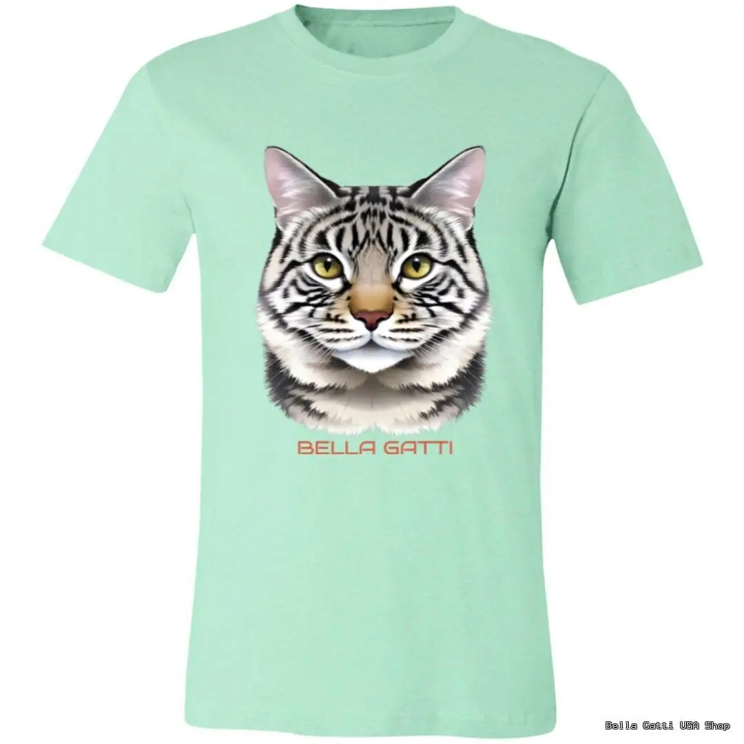 A mint green t-shirt features a realistic illustration of a gray tabby cats face, with green eyes and pink ears. Below the cat’s face, the words “BELLA GATTI” are printed in bold, light red capital letters.