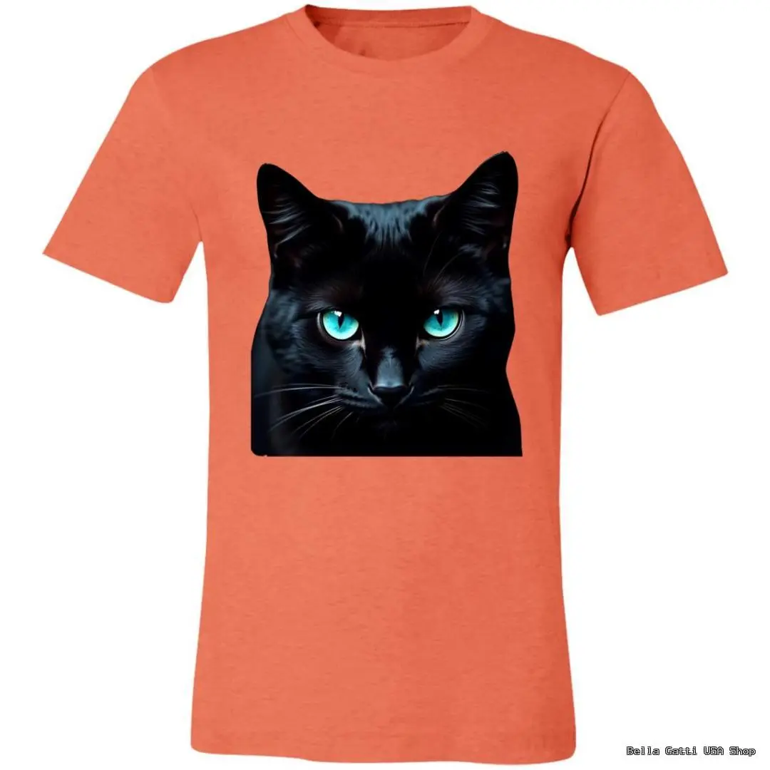A coral-colored T-shirt features a vivid, square image of a black cat with bright blue, piercing eyes seen from the front. The cats intense gaze and glossy fur contrast sharply against the shirts solid background.