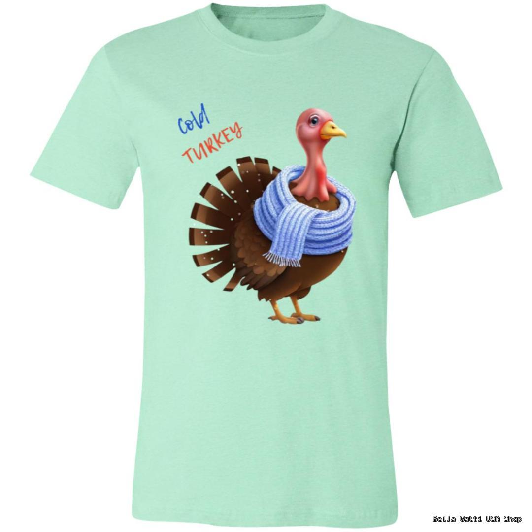 A mint green T-shirt features a cartoon turkey wearing a blue knit scarf. Above the turkey, the words Cold Turkey are written in blue and red. The design is playful and humorous, matching the phrase with the bundled-up bird.
