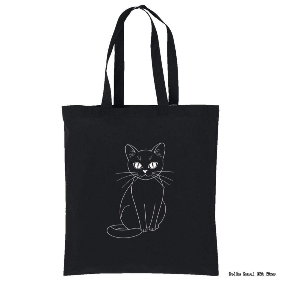 A black tote bag features a simple white line drawing of a seated cat, facing forward with its tail curled around its body. The cat has large eyes and long whiskers. The background is plain white.