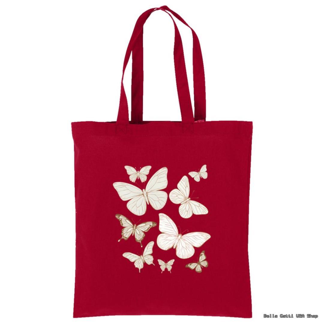 A red tote bag with two handles featuring a design of eight white and gold butterflies of various sizes grouped together in the center. The background is plain, highlighting the butterfly illustration.