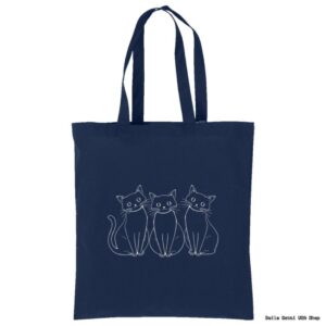 A navy blue tote bag with an illustration of three white-outlined, wide-eyed cats sitting side by side on the front. The cats have simple, cartoon-like features and are centered on the bag. The handles are long and match the bag’s color.