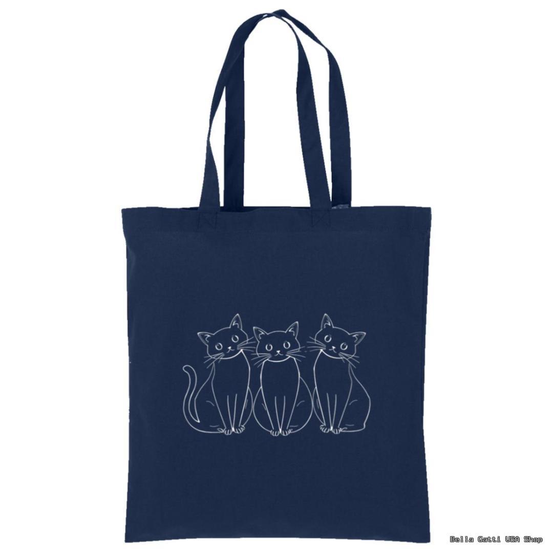 A navy blue tote bag with an illustration of three white-outlined, wide-eyed cats sitting side by side on the front. The cats have simple, cartoon-like features and are centered on the bag. The handles are long and match the bag’s color.