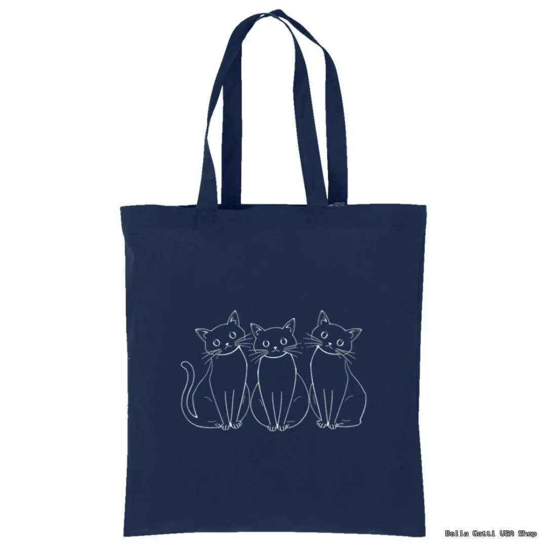 A navy blue tote bag with an illustration of three white-outlined, wide-eyed cats sitting side by side on the front. The cats have simple, cartoon-like features and are centered on the bag. The handles are long and match the bag’s color.
