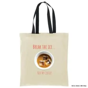 A beige tote bag with black handles features an image of a cup of iced coffee with three ice cubes. Above the cup, red text reads BREAK THE ICE.. and below it, NOT MY COFFEE! is written in red.