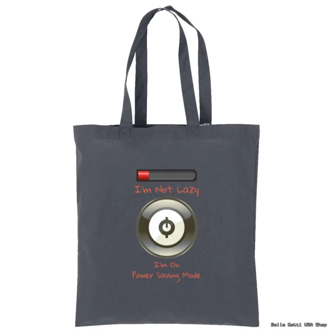 A dark gray tote bag with two handles. On it is a low battery icon above the text Im Not Lazy in orange, and beneath a large power button symbol with the text Im On Power Saving Mode in orange below it.