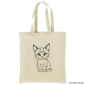 A beige tote bag features a simple black line drawing of a cute, sitting kitten with wide eyes and a small smile. The kitten has slightly rosy cheeks. The background is plain white.