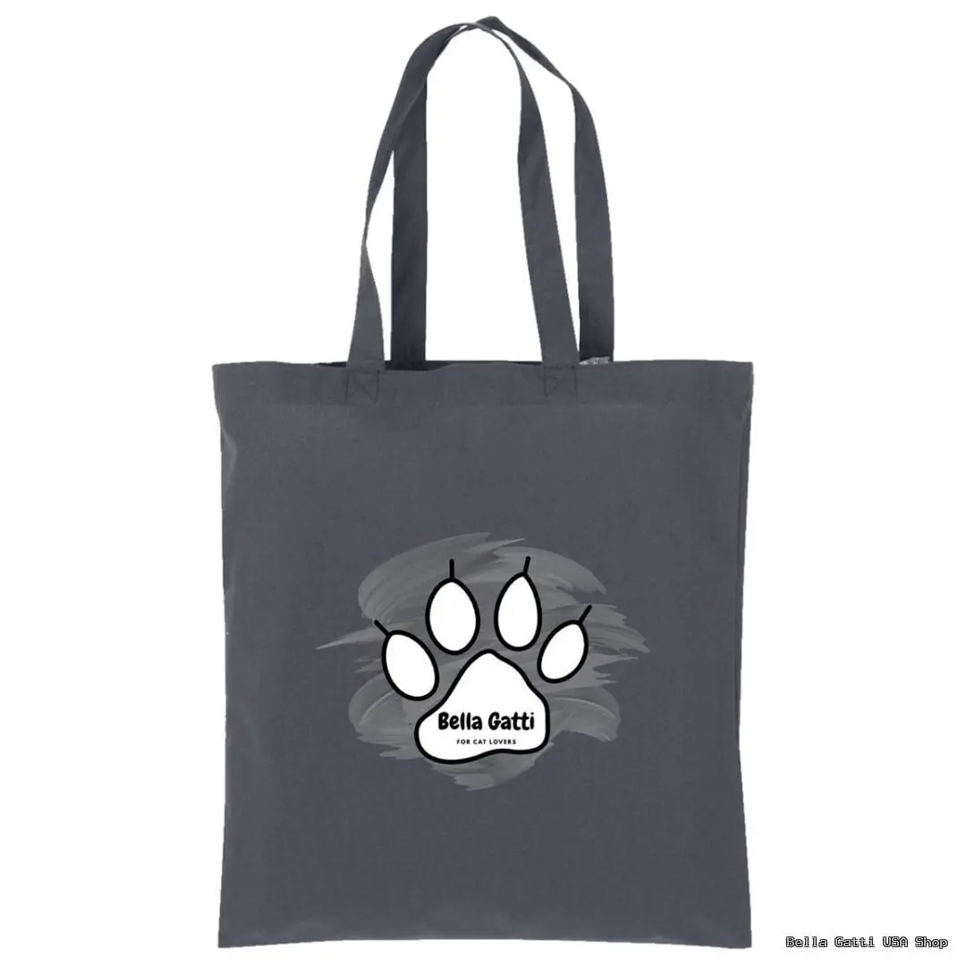 A dark gray tote bag with two handles. The front features a white cat paw print outlined in black, set against a gray paint-like swirl. Inside the paw print, the words “Bella Gatti for cat lovers” are written in black text.