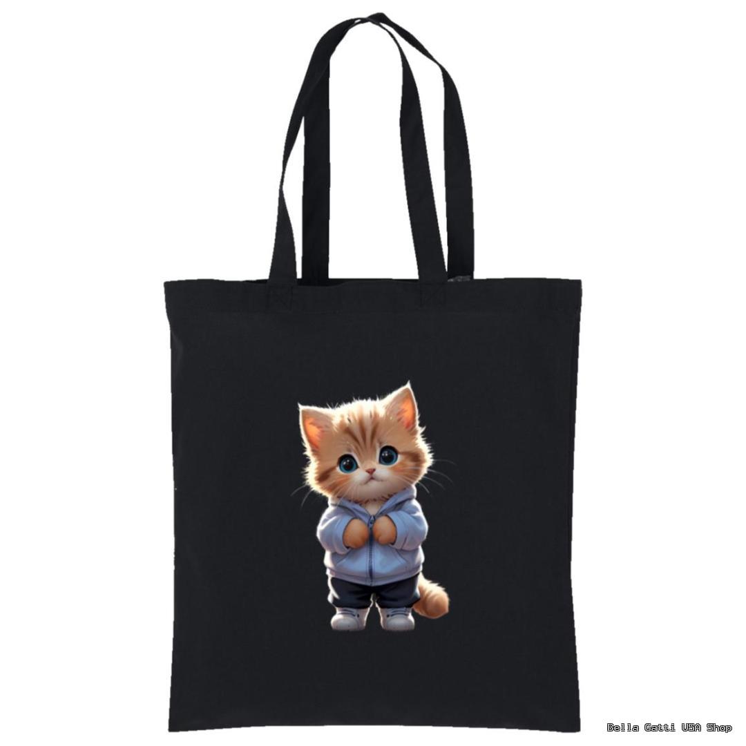 A black tote bag featuring an illustration of a cute orange and white kitten with big blue eyes, standing upright and wearing a light blue hoodie and sneakers. The kitten appears centered on the bag’s front.
