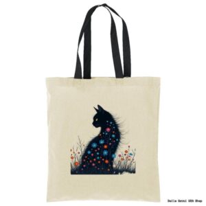 A beige tote bag with black handles features an illustration of a black cat sitting among colorful flowers. The cats fur blends into the floral design, and its yellow eyes stand out, creating a whimsical, artistic look.