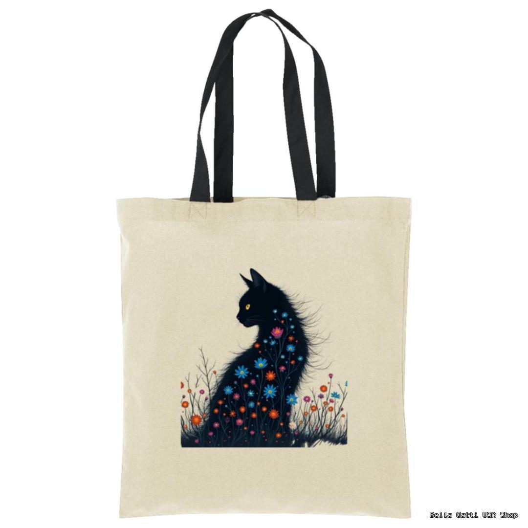 A beige tote bag with black handles features an illustration of a black cat sitting among colorful flowers. The cats fur blends into the floral design, and its yellow eyes stand out, creating a whimsical, artistic look.