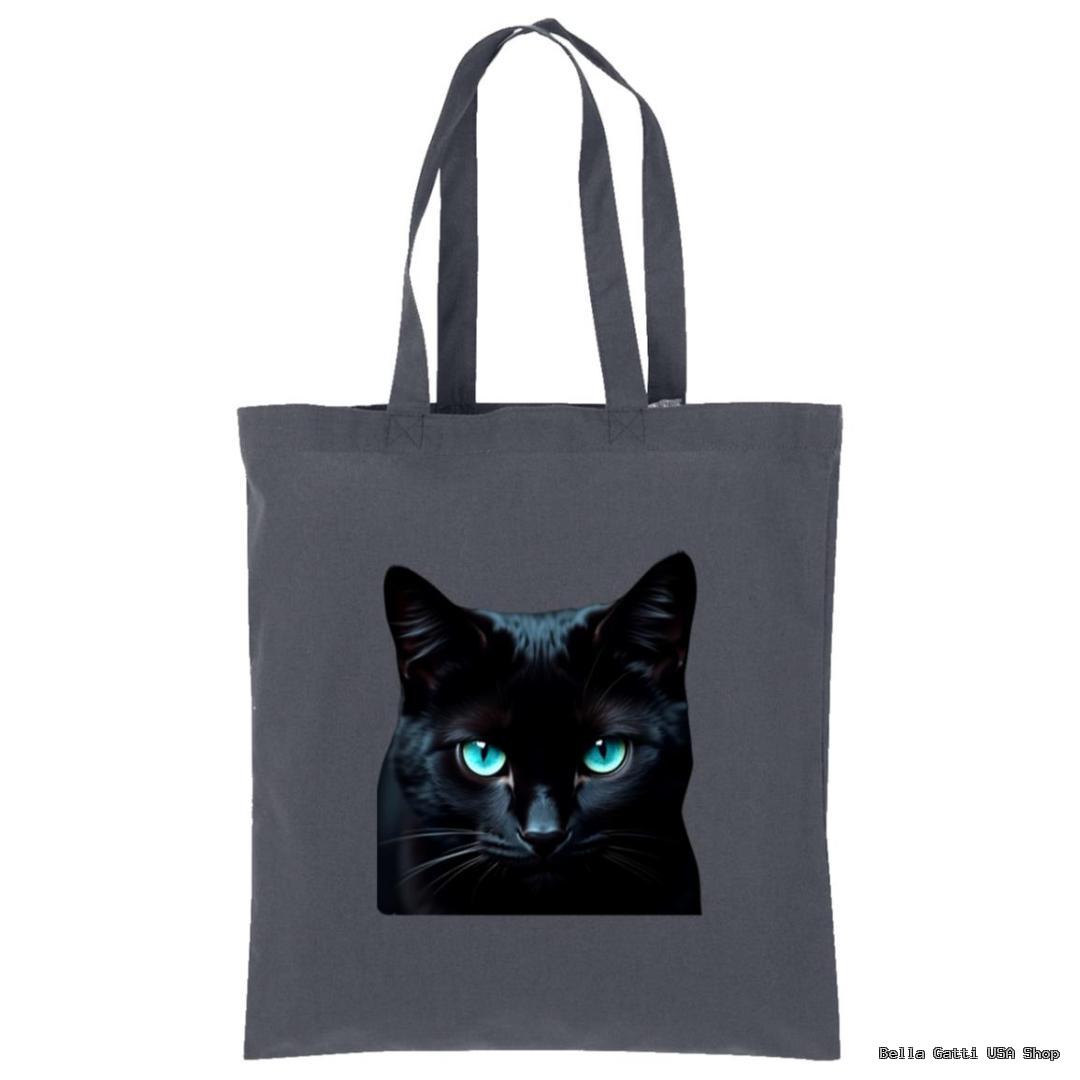 A dark gray tote bag features a realistic print of a black cat’s face with striking, bright blue eyes centered on the front. The bag has two long handles and is displayed against a plain white background.