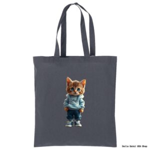 A gray tote bag features an illustration of an orange tabby kitten standing upright. The kitten is wearing a light blue hoodie, blue jeans, and sneakers, with its paws in its pockets, giving it a cool and casual appearance.